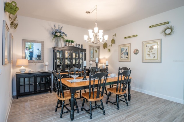 dining room featuring an inviting chandelier and light wood-type flooring