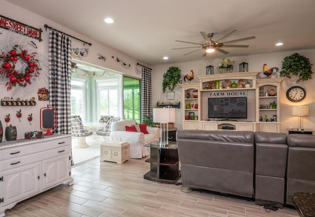 living room with ceiling fan and light hardwood / wood-style floors