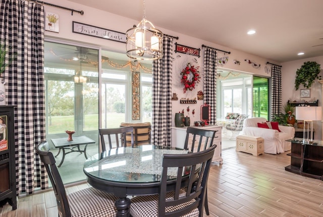 dining area featuring light hardwood / wood-style floors and an inviting chandelier