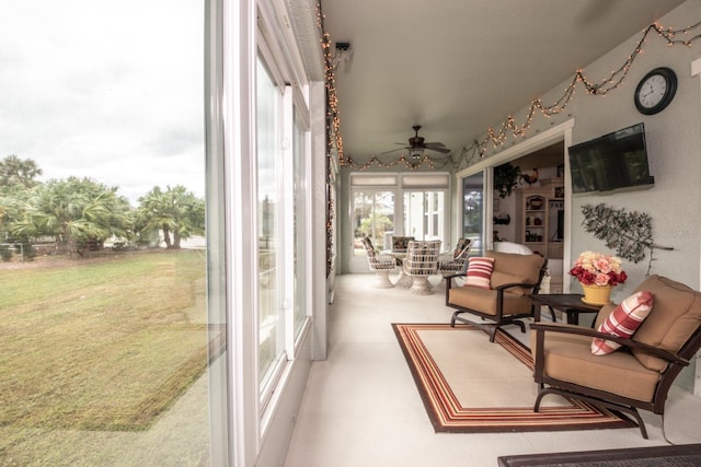 sunroom / solarium featuring ceiling fan