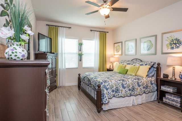 bedroom with light hardwood / wood-style flooring and ceiling fan