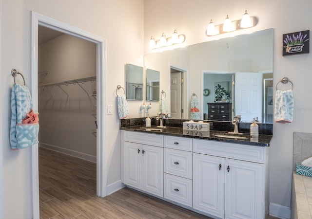 bathroom with vanity and hardwood / wood-style flooring