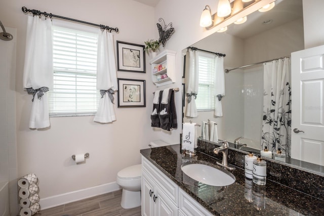 bathroom featuring toilet, vanity, and hardwood / wood-style flooring