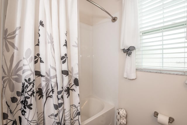 bathroom with shower / bath combo with shower curtain