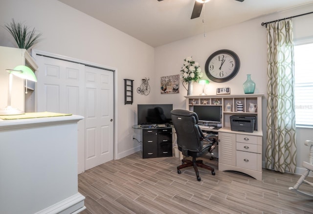 home office featuring light wood-type flooring and ceiling fan