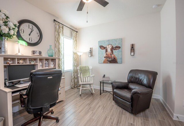 home office with wood-type flooring and ceiling fan