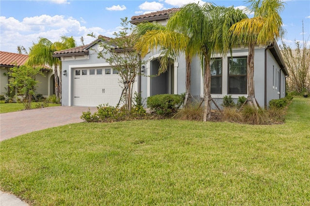 mediterranean / spanish-style home with a garage and a front lawn