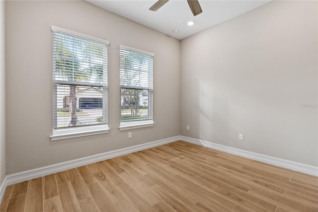 spare room featuring ceiling fan and light hardwood / wood-style flooring