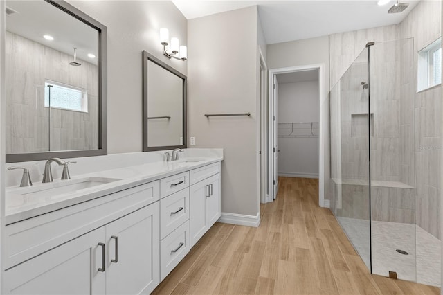 bathroom featuring tiled shower, plenty of natural light, and hardwood / wood-style flooring