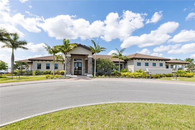 mediterranean / spanish-style house featuring a front lawn