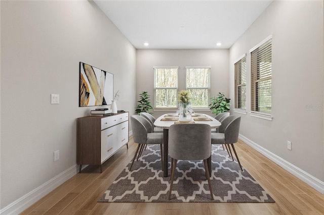 dining space with light hardwood / wood-style floors