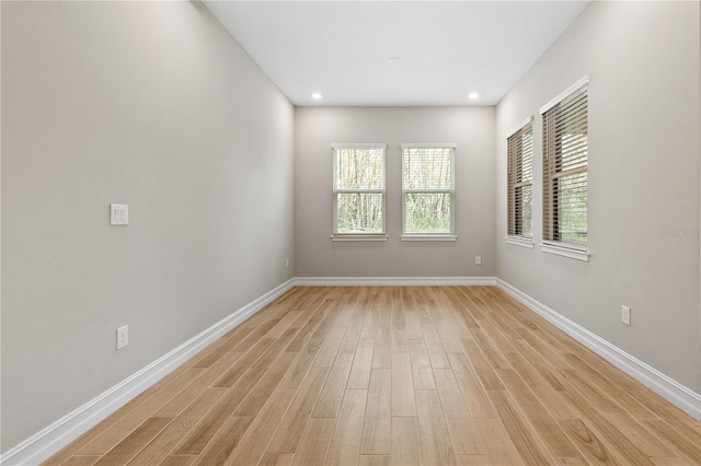 spare room featuring light hardwood / wood-style floors