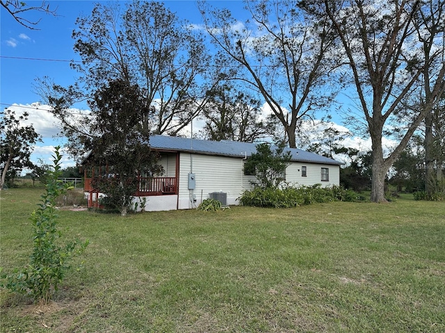 exterior space with central AC unit and a wooden deck