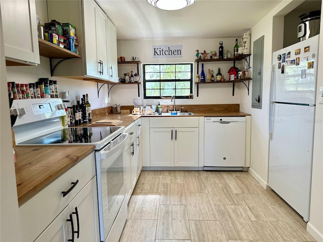 kitchen featuring wooden counters, white appliances, and white cabinets