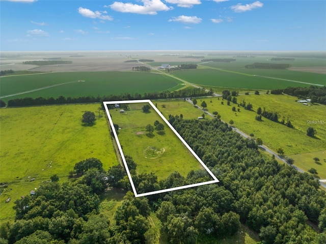 birds eye view of property with a rural view