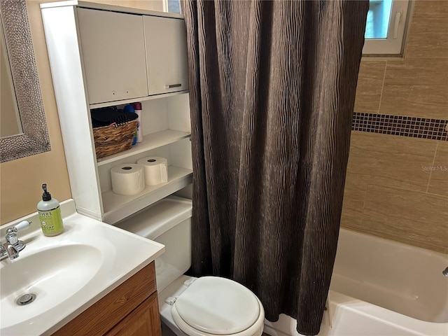 full bathroom with vanity, shower / bath combo with shower curtain, and toilet