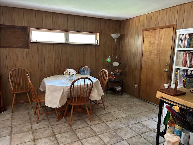 dining room with wooden walls