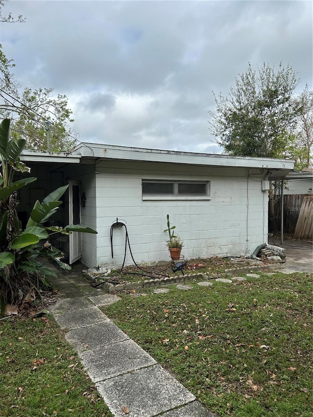 view of side of property with a lawn