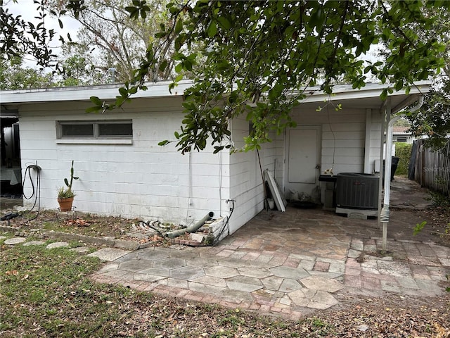 back of property featuring cooling unit and a patio area