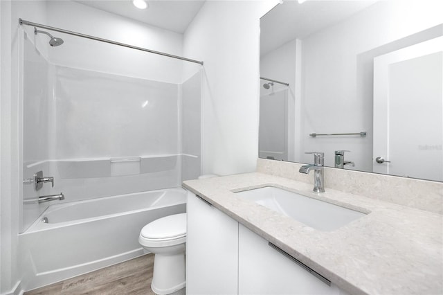 full bathroom featuring hardwood / wood-style flooring, vanity, shower / bathtub combination, and toilet