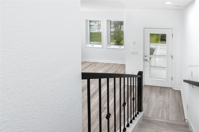 staircase with hardwood / wood-style floors