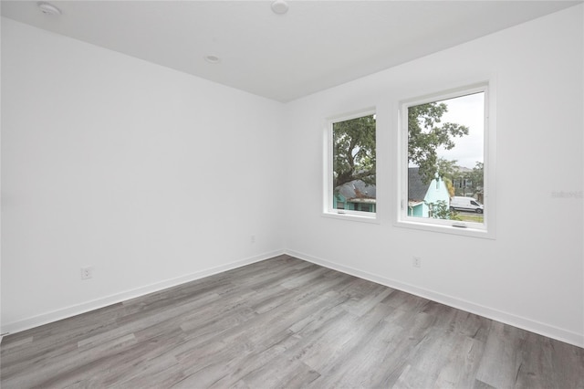 unfurnished room featuring light hardwood / wood-style floors and a healthy amount of sunlight