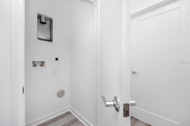 laundry area with hookup for an electric dryer, light wood-type flooring, and hookup for a washing machine