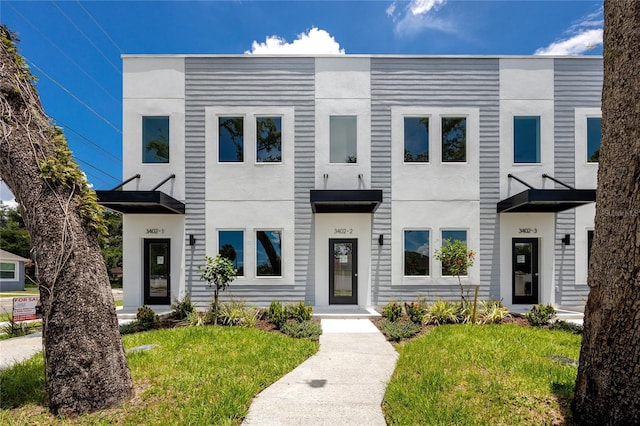3402 E 28th Ave Unit 1, Tampa, FL 33605 - view of front facade with a front lawn and stucco siding
