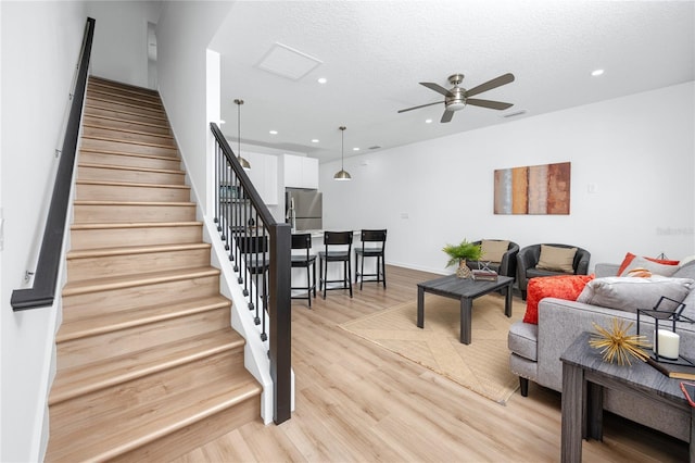 3402 E 28th Ave Unit 1, Tampa, FL 33605 - living room with stairway, a ceiling fan, light wood finished floors, recessed lighting, and a textured ceiling