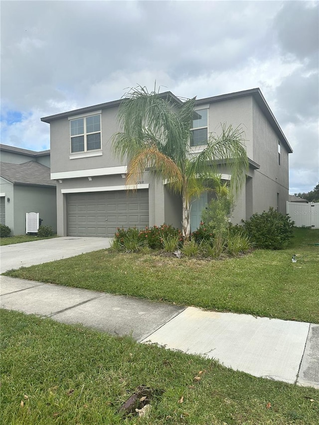 view of front of property with a garage and a front lawn