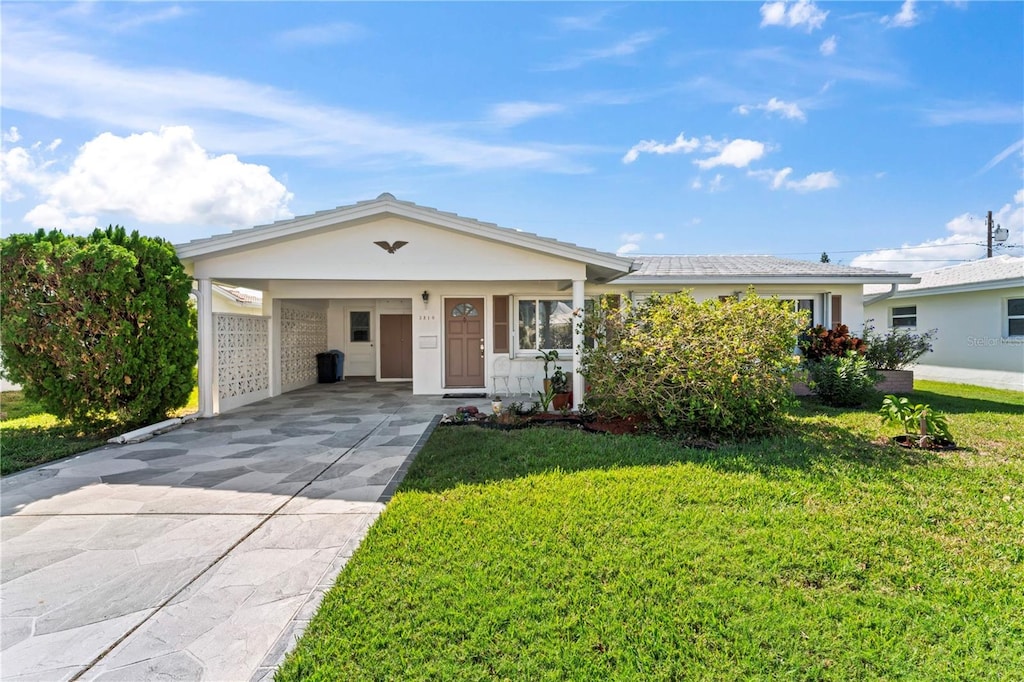 single story home with a front yard and a carport