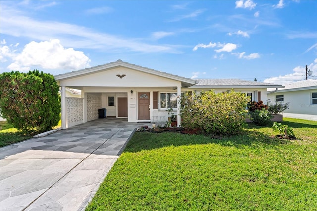 single story home with a front yard and a carport