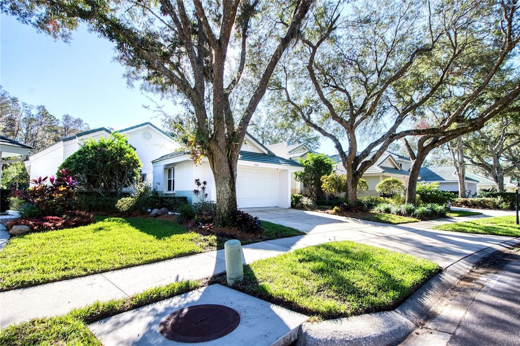 view of front of home featuring a front yard and a garage