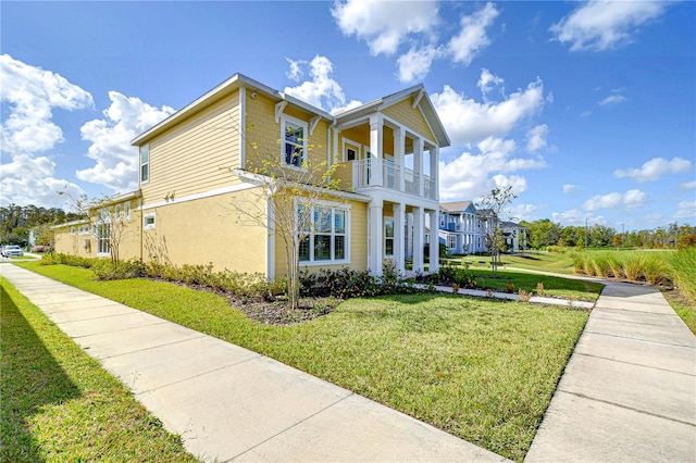 view of property exterior featuring a lawn and a balcony