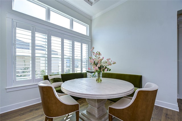 dining space featuring crown molding, breakfast area, a healthy amount of sunlight, and dark hardwood / wood-style floors