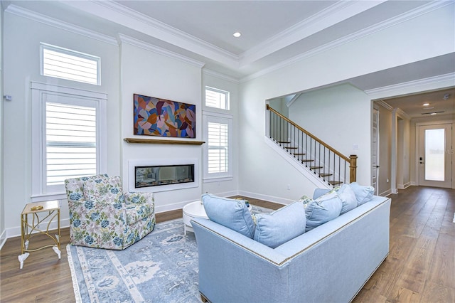 living room featuring hardwood / wood-style flooring and ornamental molding