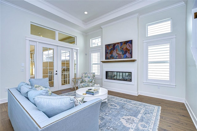 living room with dark hardwood / wood-style flooring, crown molding, and french doors