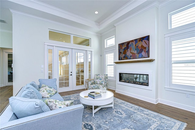 living room featuring french doors, a healthy amount of sunlight, and dark hardwood / wood-style floors