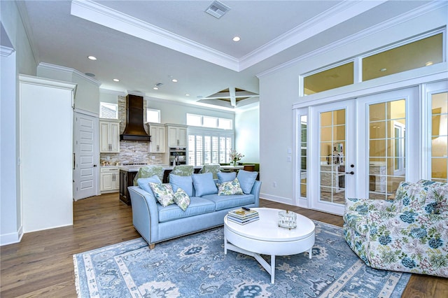 living room featuring dark hardwood / wood-style flooring, crown molding, and french doors