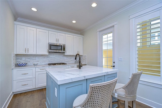 kitchen with white cabinets, plenty of natural light, and stainless steel appliances