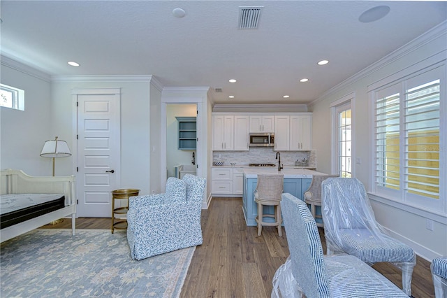 interior space featuring ornamental molding, a healthy amount of sunlight, and light wood-type flooring