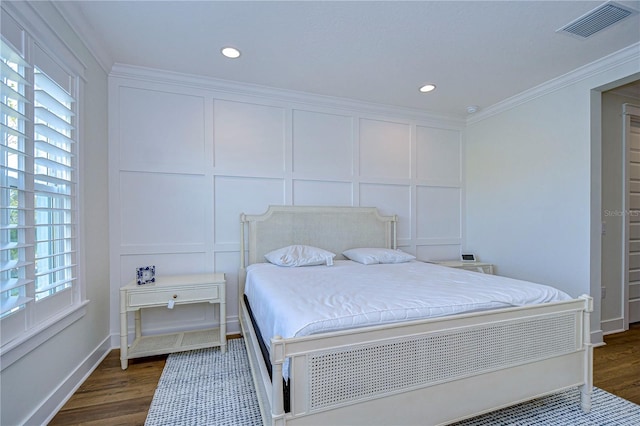 bedroom featuring crown molding and dark hardwood / wood-style flooring