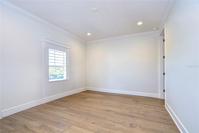 spare room featuring light hardwood / wood-style floors and ornamental molding