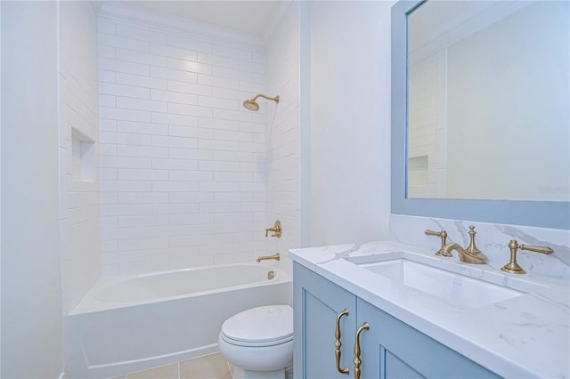 full bathroom featuring tile patterned floors, vanity, tiled shower / bath combo, crown molding, and toilet