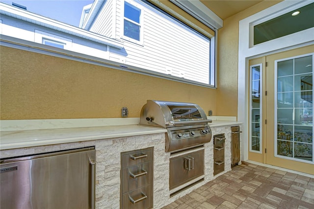 view of patio with area for grilling and exterior kitchen