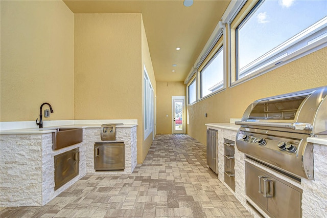 view of patio / terrace with a grill and sink