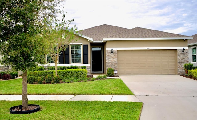 view of front of home featuring a garage and a front yard