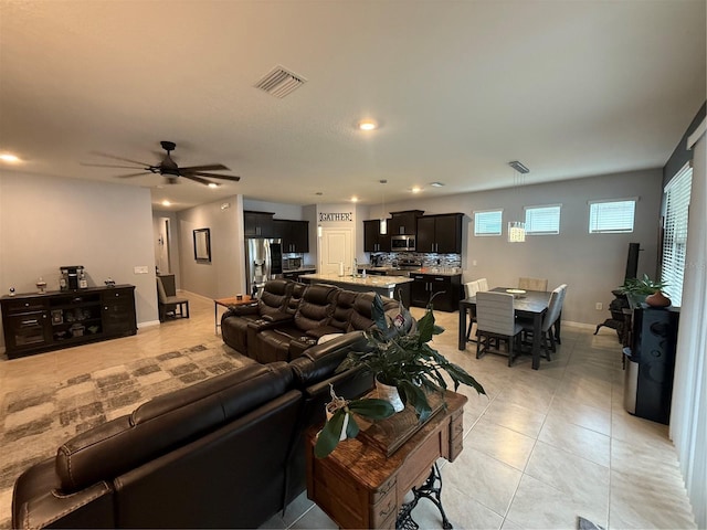 tiled living room with ceiling fan