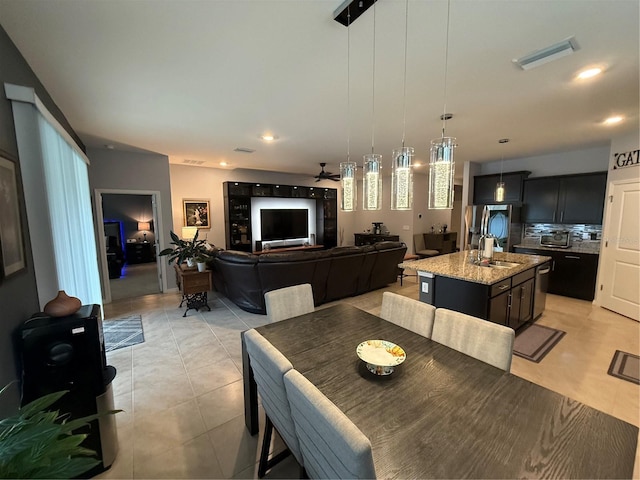 dining area with sink, ceiling fan, and light tile patterned floors