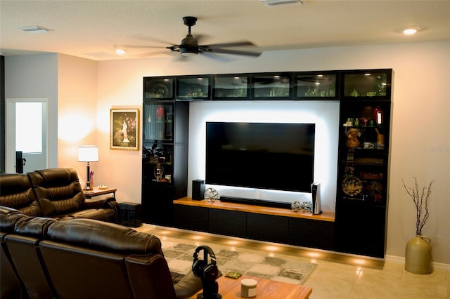 living room with ceiling fan and light tile patterned floors